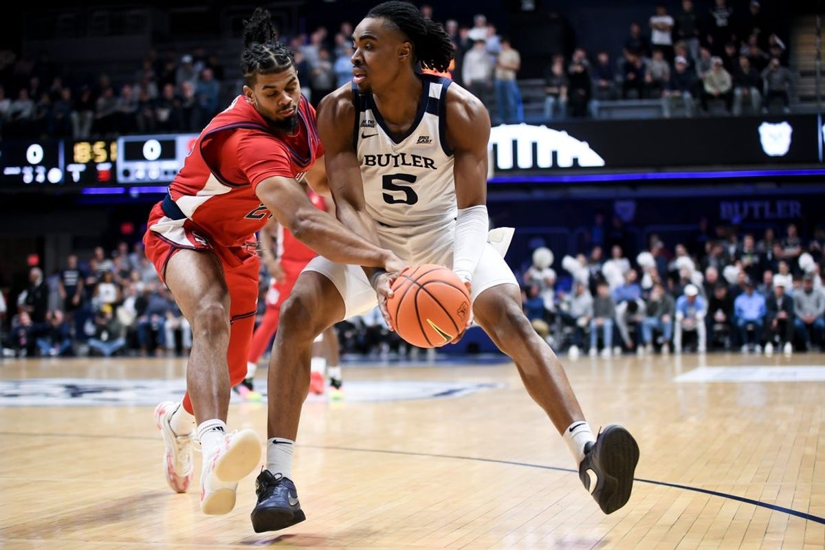 Jan 6, 2026; Indianapolis, Indiana, USA; St. John's Red Storm forward Bryce Hopkins (23) fouls Butler Bulldogs forward Michael Ajayi (5) during the first half at Hinkle Fieldhouse. Mandatory Credit: Robert Goddin-Imagn Images