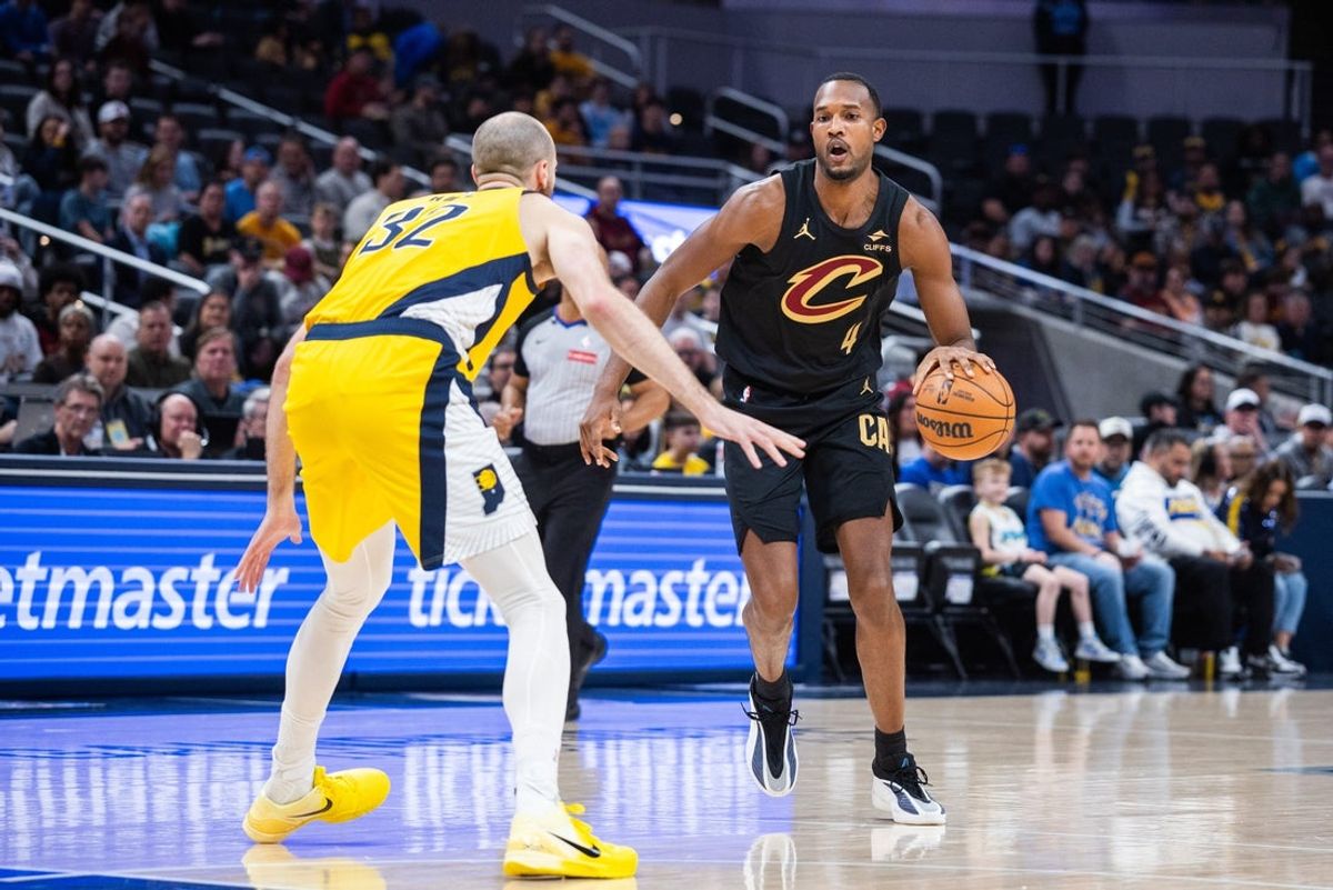 Jan 6, 2026; Indianapolis, Indiana, USA;  Cleveland Cavaliers center Evan Mobley (4) dribbles the ball while  Indiana Pacers center Jay Huff (32) defends in the first half at Gainbridge Fieldhouse. Mandatory Credit: Trevor Ruszkowski-Imagn Images