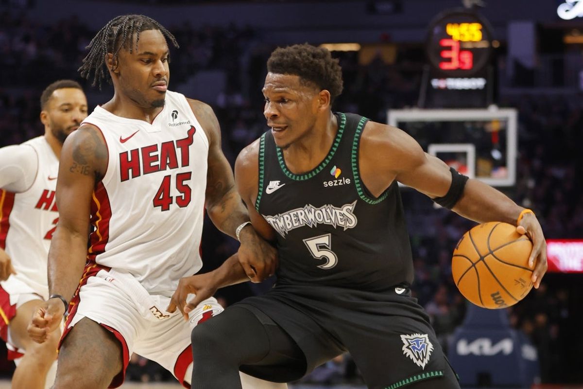 Jan 6, 2026; Minneapolis, Minnesota, USA; Minnesota Timberwolves guard Anthony Edwards (5) works around Miami Heat guard Davion Mitchell (45) in the first quarter at Target Center. Mandatory Credit: Bruce Kluckhohn-Imagn Images