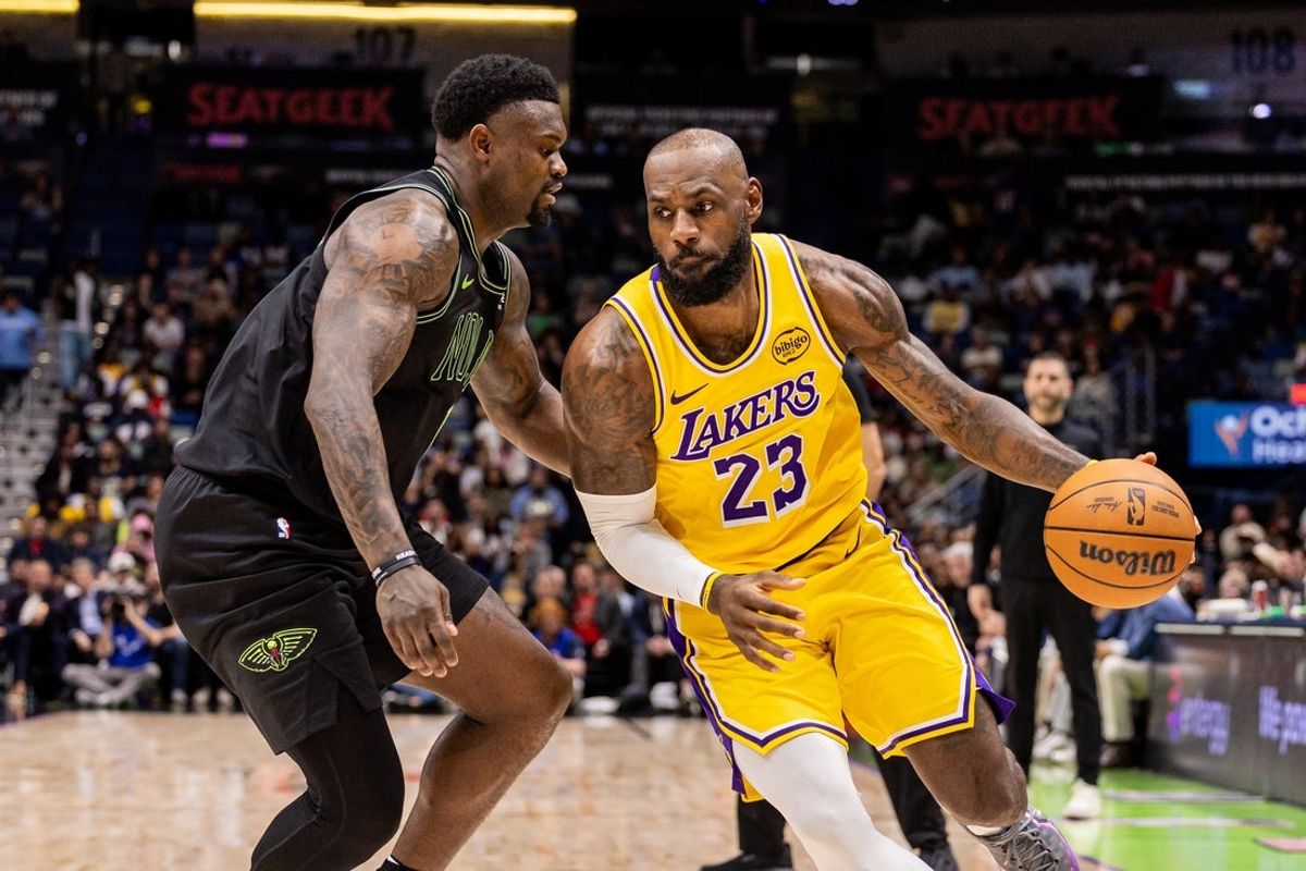 Jan 6, 2026; New Orleans, Louisiana, USA;  Los Angeles Lakers forward LeBron James (23) dribbles against New Orleans Pelicans forward Zion Williamson (1) during the first half at Smoothie King Center. Mandatory Credit: Stephen Lew-Imagn Images