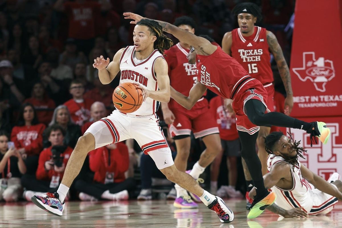 Jan 6, 2026; Houston, Texas, USA; Houston Cougars guard Kingston Flemings (4) attempts to get a rebound away from Texas Tech Red Raiders guard Jaylen Petty (11) during the first half at Fertitta Center. Mandatory Credit: Troy Taormina-Imagn Images