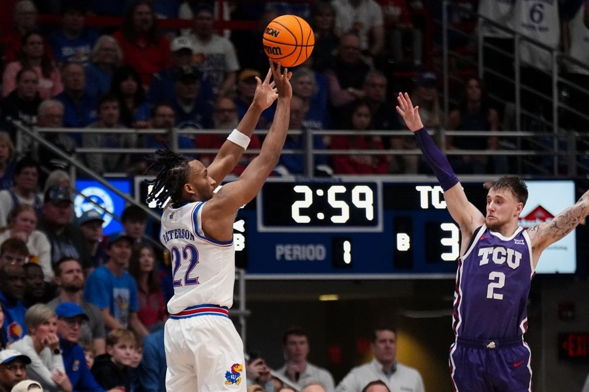 Jan 6, 2026; Lawrence, Kansas, USA; Kansas Jayhawks guard Darryn Peterson (22) shoots over TCU Horned Frogs guard Brock Harding (2) during the first half of the game at Allen Fieldhouse. Mandatory Credit: Denny Medley-Imagn Images
