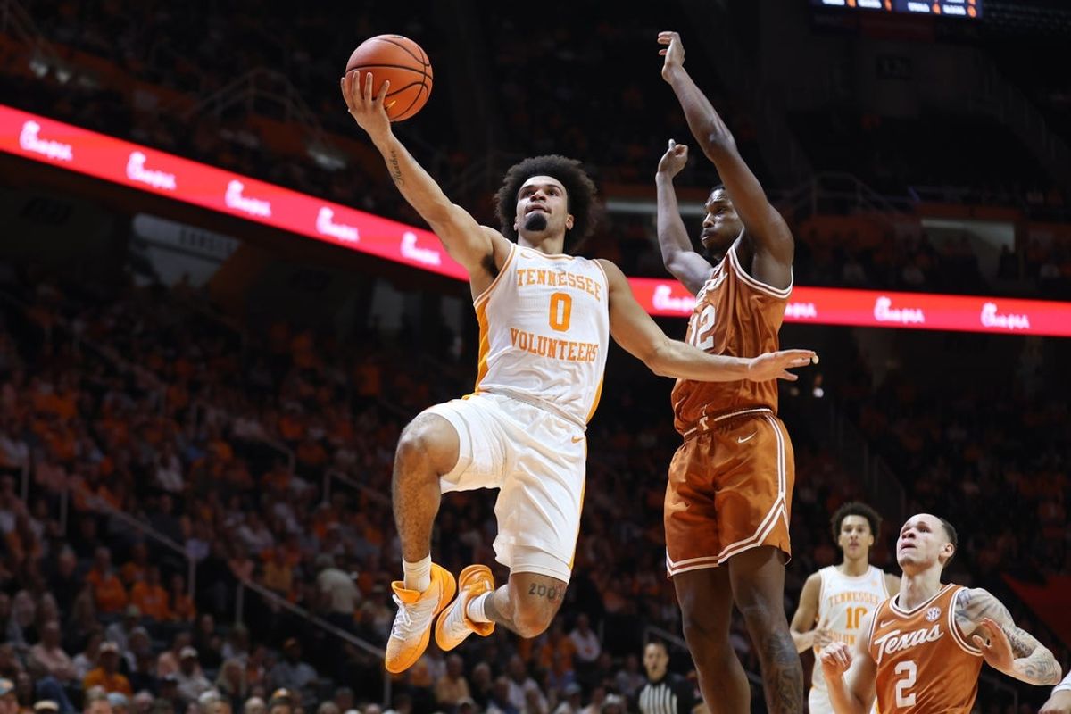 Jan 6, 2026; Knoxville, Tennessee, USA;  Tennessee Volunteers guard Ja'kobi Gillespie (0) goes to the basket against Texas Longhorns guard Tramon Mark (12) during the first half at Thompson-Boling Arena at Food City Center. Mandatory Credit: Randy Sartin-Imagn Images