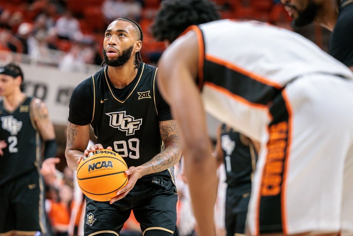 Jan 6, 2026; Stillwater, Oklahoma, USA; UCF Knights forward Jordan Burks (99) shoots a free throw during the second half against the Oklahoma State Cowboys at Gallagher-Iba Arena. Mandatory Credit: William Purnell-Imagn Images