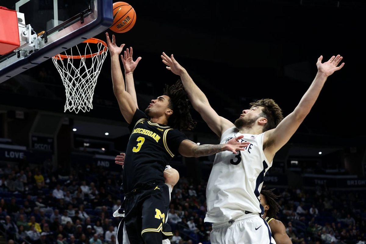 Jan 6, 2026; University Park, Pennsylvania, USA; Michigan Wolverines guard Elliot Cadeau (3) drives the ball to the basket as Penn State Nittany Lions forward Ivan Juric (3) defends during the second half at Bryce Jordan Center. Mandatory Credit: Matthew O'Haren-Imagn Images