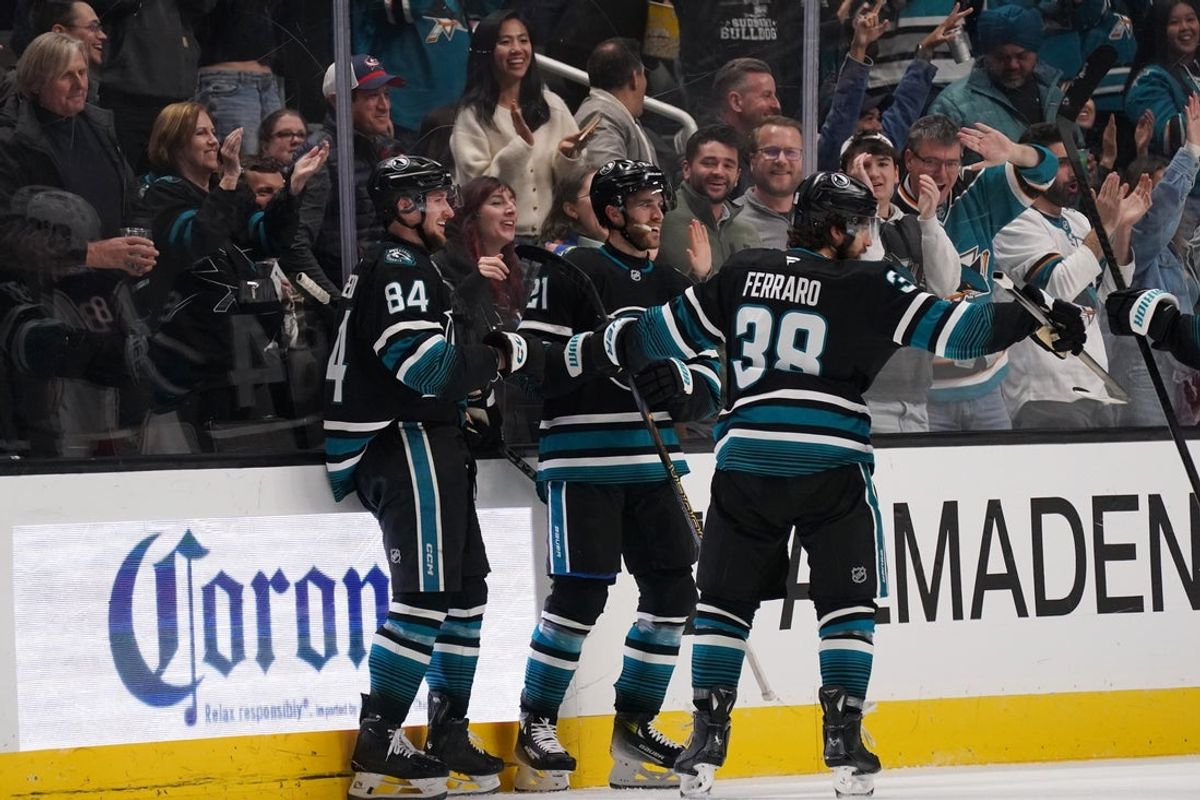 Jan 6, 2026; San Jose, California, USA; San Jose Sharks left wing Pavol Regenda (84) celebrates with center Alexander Wennberg (21) and defenseman Mario Ferraro (38) after scoring a goal in the first period against the Columbus Blue Jackets at SAP Center at San Jose. Mandatory Credit: David Gonzales-Imagn Images