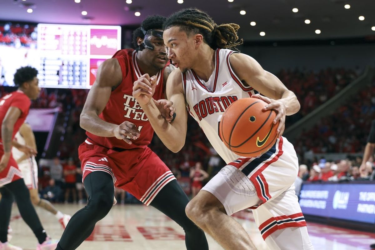 Jan 6, 2026; Houston, Texas, USA; Houston Cougars guard Kingston Flemings (4) drives with the ball as Texas Tech Red Raiders guard Jaylen Petty (11) defends during the second half at Fertitta Center. Mandatory Credit: Troy Taormina-Imagn Images
