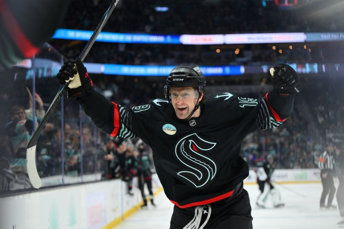 Jan 6, 2026; Seattle, Washington, USA; Seattle Kraken left wing Jared McCann (19) celebrates with center Berkly Catton (27) after Catton scored his first NHL goal during the second period against the Boston Bruins at Climate Pledge Arena. Mandatory Credit: Steven Bisig-Imagn Images