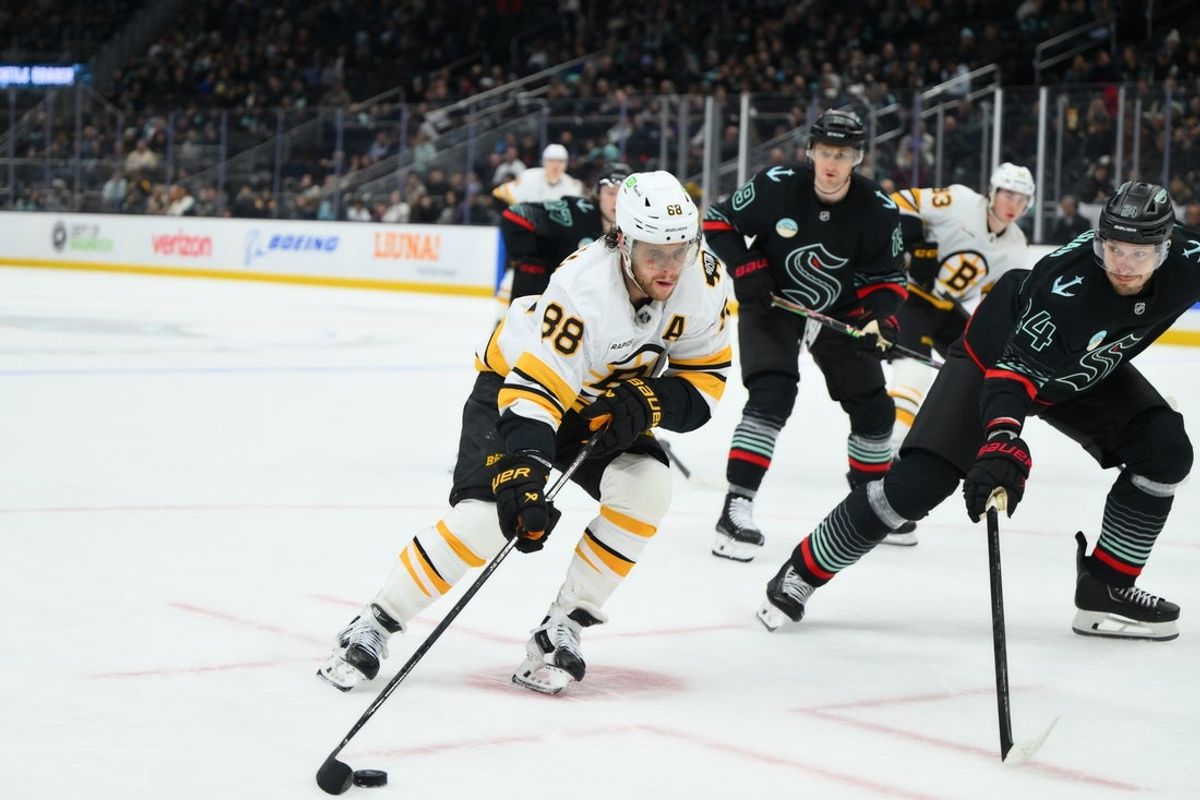 Jan 6, 2026; Seattle, Washington, USA; Boston Bruins right wing David Pastrnak (88) advances the puck against the Seattle Kraken during the third period at Climate Pledge Arena. Mandatory Credit: Steven Bisig-Imagn Images