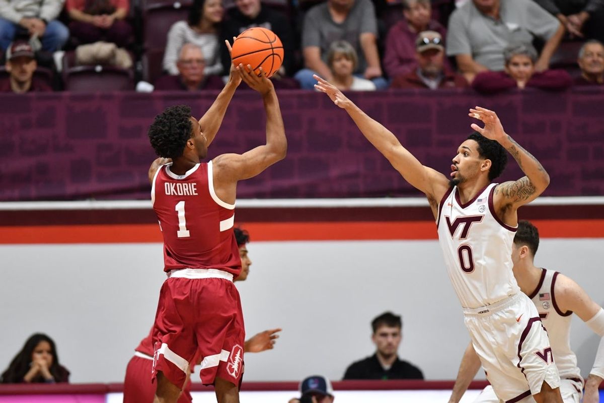 Jan 7, 2026; Blacksburg, Virginia, USA;  Stanford Cardinal guard Ebuka Okorie (1) shoots a shot as Virginia Tech Hokies guard Jailen Bedford (0) defends during the first half at Cassell Coliseum. Mandatory Credit: Brian Bishop-Imagn Images