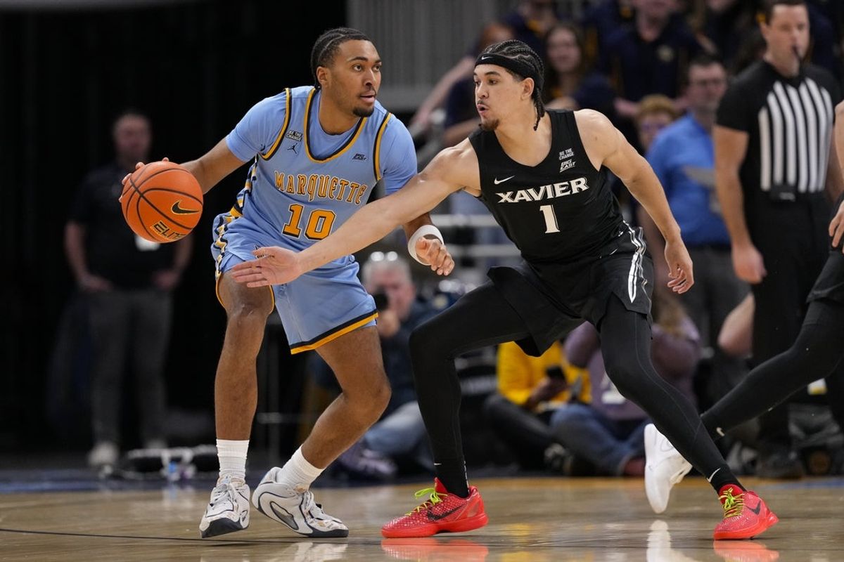 Jan 7, 2026; Milwaukee, Wisconsin, USA;  Xavier Musketeers guard Malik Messina-Moore (1) defends Marquette Golden Eagles guard Adrien Stevens (10) during the first half at Fiserv Forum. Mandatory Credit: Jeff Hanisch-Imagn Images