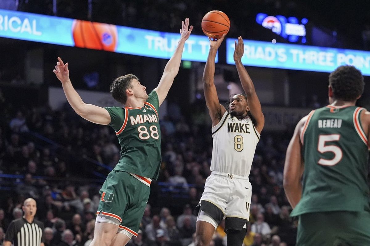 Jan 7, 2026; Winston-Salem, North Carolina, USA; Wake Forest Demon Deacons guard Mekhi Mason (8) shoots over Miami (FL) Hurricanes forward Timotej Malovec (88) during the first half at Lawrence Joel Veterans Memorial Coliseum. Mandatory Credit: Jim Dedmon-Imagn Images