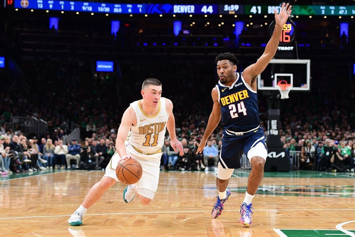Jan 7, 2026; Boston, Massachusetts, USA; Boston Celtics guard Payton Pritchard (11) controls the ball while Denver Nuggets guard Jalen Pickett (24) defends during the first half at TD Garden. Mandatory Credit: Bob DeChiara-Imagn Images