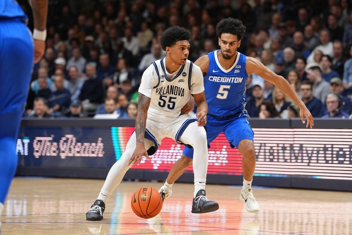 Jan 7, 2026; Villanova, Pennsylvania, USA; Villanova Wildcats guard Acaden Lewis (55) drives against Creighton Bluejays guard Nik Graves (5) in the first half at William B. Finneran Pavilion. Mandatory Credit: Kyle Ross-Imagn Images