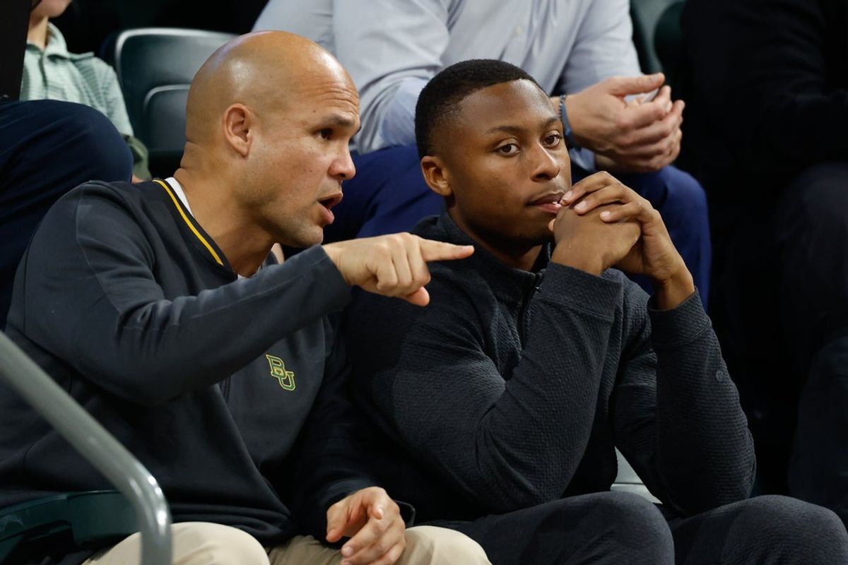 Jan 7, 2026; Waco, Texas, USA;  DJ Lagway, a Florida quarterback currently in the transfer portal, sits with Baylor Bears football head coach Dave Aranda, left, during the first half of a game between the Baylor Bears and Iowa State Cyclones at Paul and Alejandra Foster Pavilion. Mandatory Credit: Chris Jones-Imagn Images