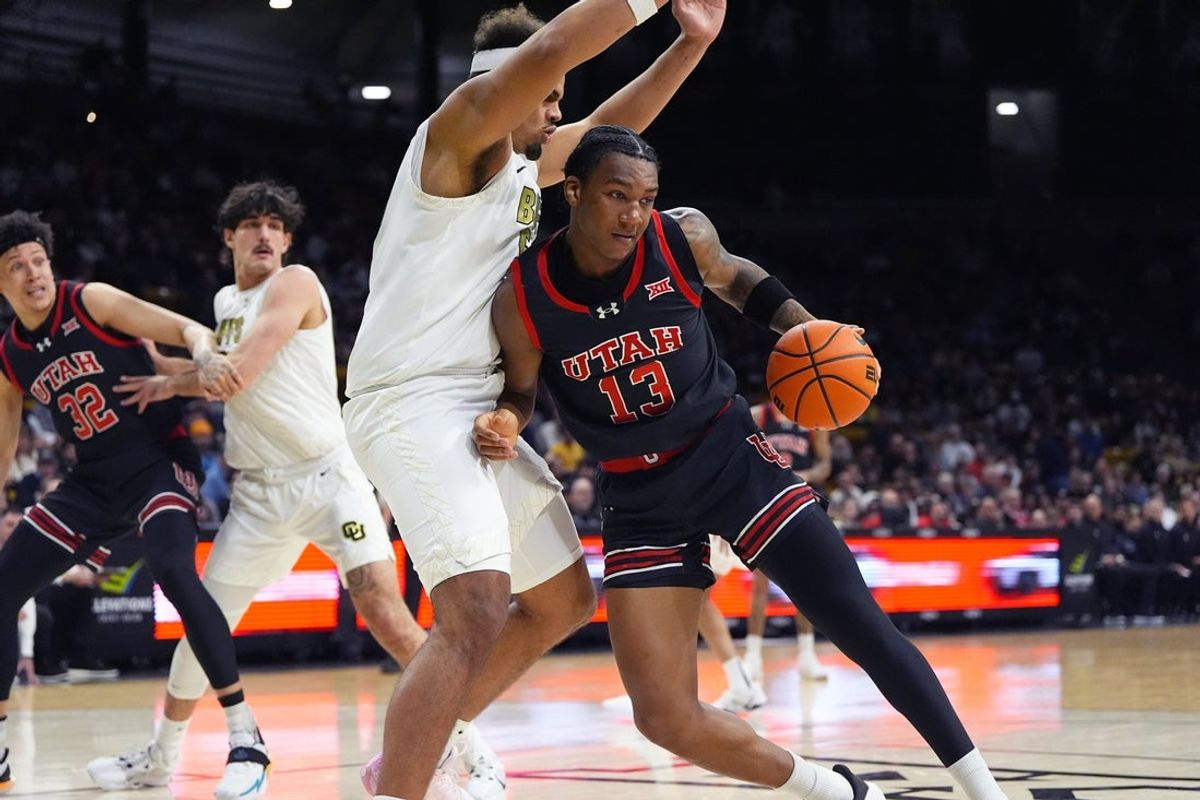 Jan 7, 2026; Boulder, Colorado, USA; Colorado Buffaloes center Elijah Malone (50) defends against Utah Utes forward Kendyl Sanders (13) in the first that at CU Events Center. Mandatory Credit: Ron Chenoy-Imagn Images