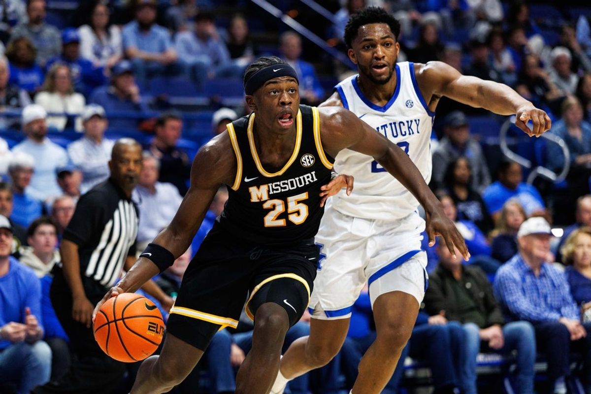 Jan 7, 2026; Lexington, Kentucky, USA; Missouri Tigers forward Mark Mitchell (25) drives to the basket around Kentucky Wildcats forward Mouhamed Dioubate (23) during the first half at Rupp Arena at Central Bank Center. Mandatory Credit: Jordan Prather-Imagn Images