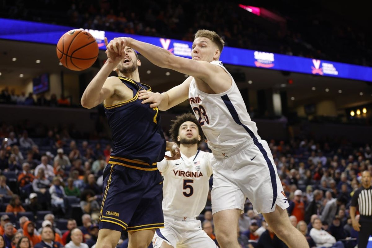 Jan 7, 2026; Charlottesville, Virginia, USA; Virginia Cavaliers forward Thijs de Ridder (28) knocks the ball away from California Golden Bears forward John Camden (2) during the first half at John Paul Jones Arena. Mandatory Credit: Amber Searls-Imagn Images