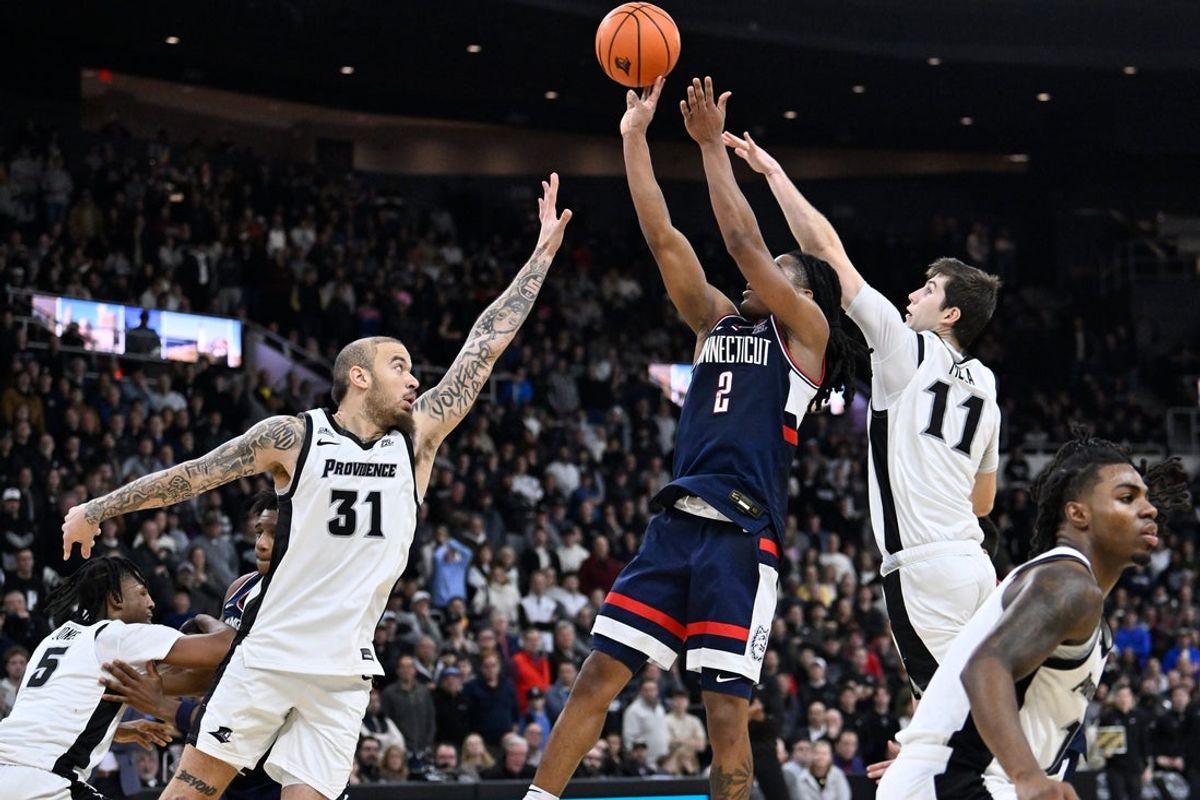 Jan 7, 2026; Providence, Rhode Island, USA; UConn Huskies guard Silas Demary Jr. (2) shoots against Providence Friars forward Duncan Powell (31) and guard Ryan Mela (11) during overtime at Amica Mutual Pavilion. Mandatory Credit: Eric Canha-Imagn Images