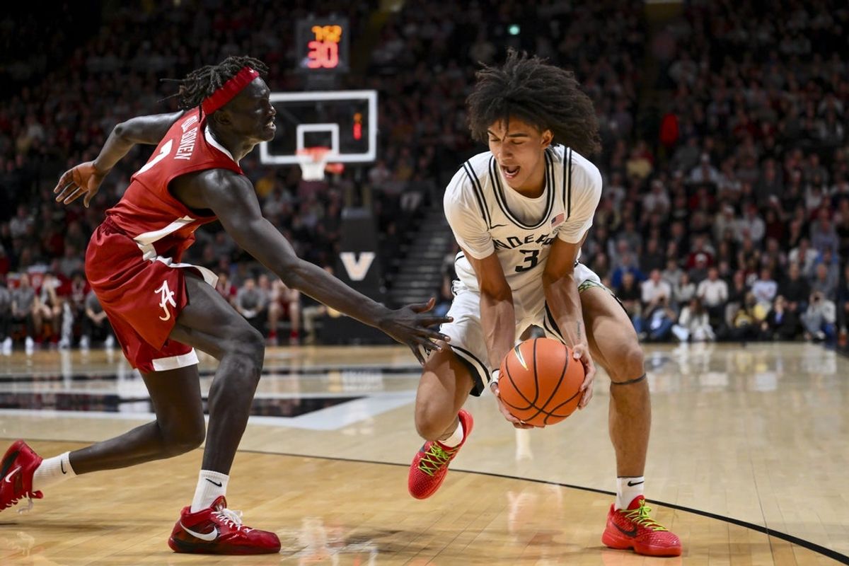 Jan 7, 2026; Nashville, Tennessee, USA; Alabama Crimson Tide forward Taylor Bol Bowen (7) tries to steal the ball from Vanderbilt Commodores guard Tyler Tanner (3) during the first half at Memorial Gymnasium. Mandatory Credit: Steve Roberts-Imagn Images