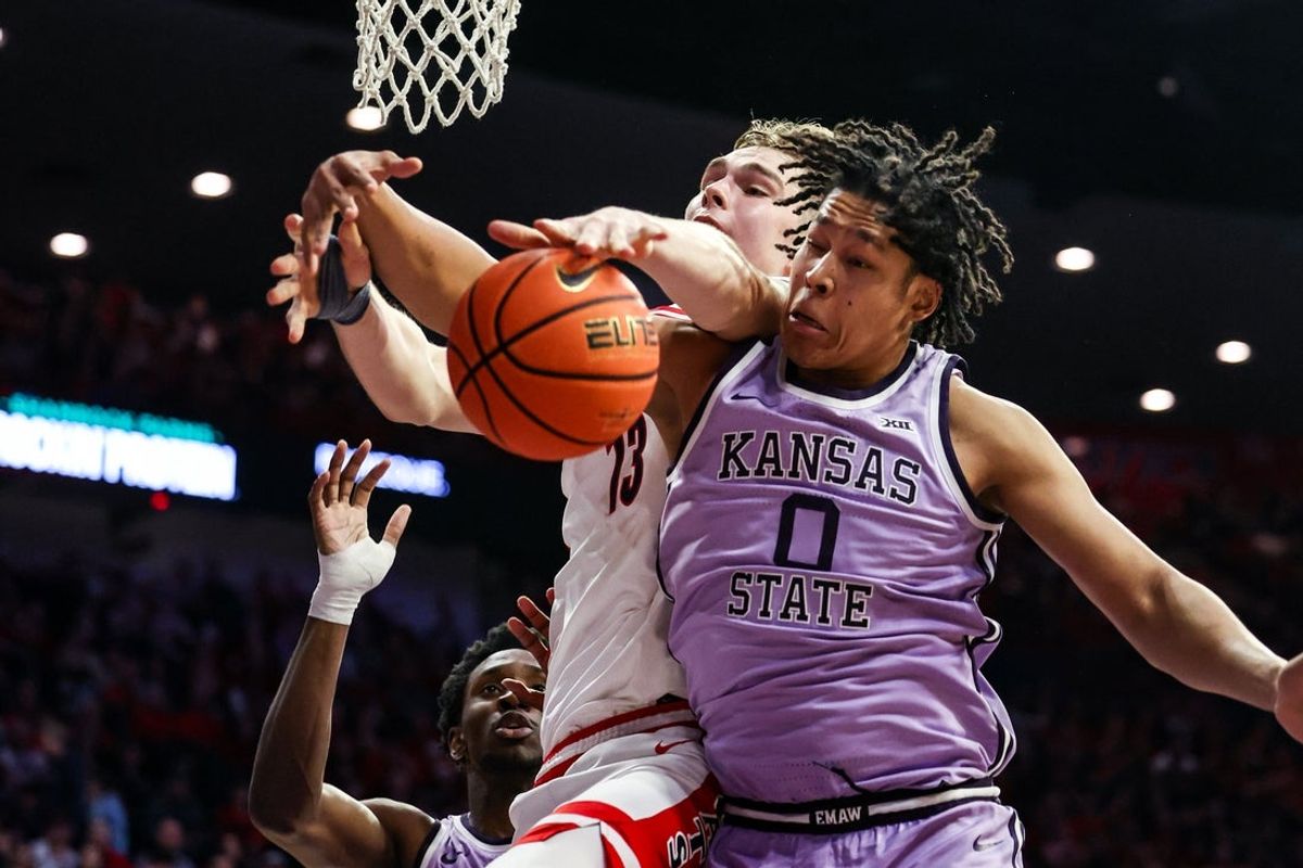 Jan 7, 2026; Tucson, Arizona, USA; Arizona Wildcats center Motiejus Krivas (13) and Kansas State Wildcats wing Elias Rapieque (0) both attempt to rebound the ball during the second half of the game at McKale Memorial Center. Mandatory Credit: Aryanna Frank-Imagn Images
