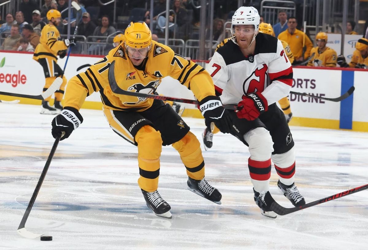 Jan 8, 2026; Pittsburgh, Pennsylvania, USA;  Pittsburgh Penguins center Evgeni Malkin (71) controls the puck against New Jersey Devils defenseman Dougie Hamilton (7) during the first period at PPG Paints Arena. Mandatory Credit: Charles LeClaire-Imagn Images