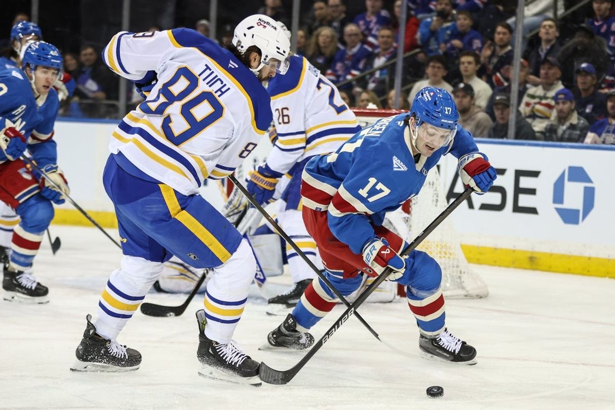 Jan 8, 2026; New York, New York, USA;  Buffalo Sabres right wing Alex Tuch (89) and New York Rangers defenseman Will Borgen (17) battle for control of the puck in the first period at Madison Square Garden. Mandatory Credit: Wendell Cruz-Imagn Images
