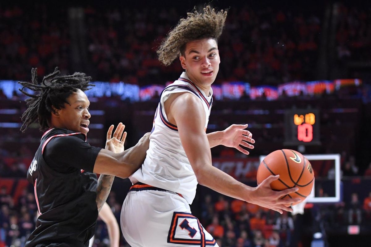 Jan 8, 2026; Champaign, Illinois, USA;  Illinois Fighting Illini guard Keaton Wagler (23) drives the ball against Rutgers Scarlet Knights guard Jamichael Davis (1) during the first half at State Farm Center. Mandatory Credit: Ron Johnson-Imagn Images