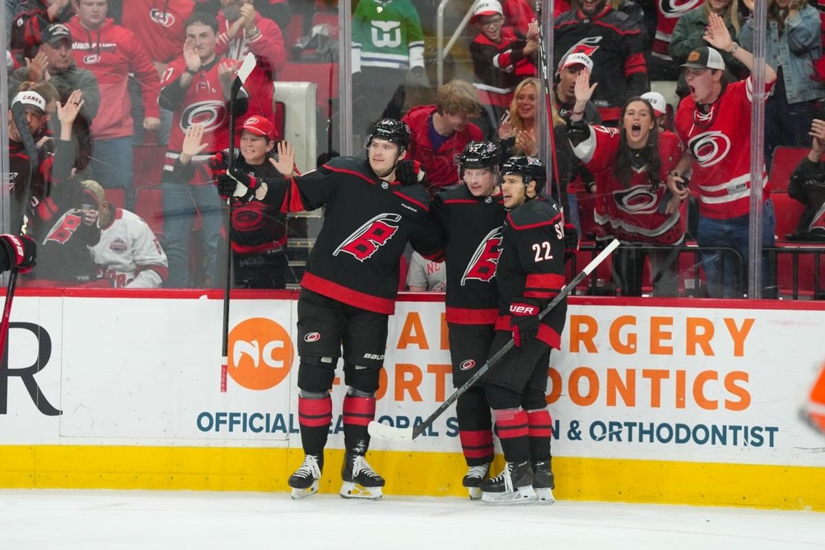 Jan 8, 2026; Raleigh, North Carolina, USA;  Carolina Hurricanes right wing Jackson Blake (53) celebrates his goal with center Logan Stankoven (22) and defenseman Alexander Nikishin (21) against the Anaheim Ducks during the third period at Lenovo Center. Mandatory Credit: James Guillory-Imagn Images