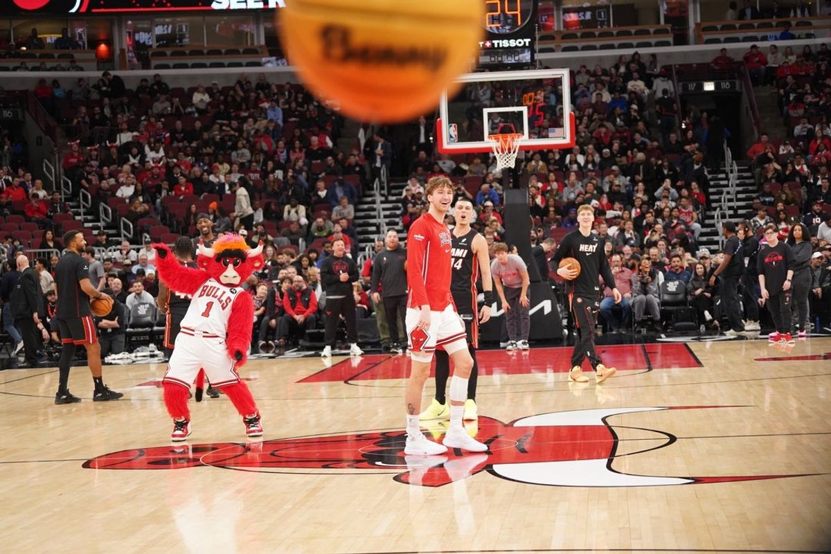Jan 8, 2026; Chicago, Illinois, USA; Chicago Bulls forward Matas Buzelis (14) and Miami Heat guard Tyler Herro (14) take backward half court shots as the game against the Miami Heat is delayed because of condensation on the court due to humidity and rain at United Center. Mandatory Credit: David Banks-Imagn Images