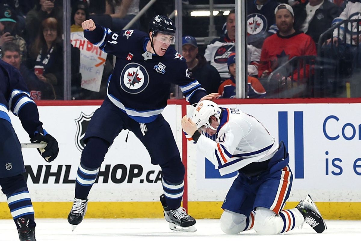 Jan 8, 2026; Winnipeg, Manitoba, CAN; Winnipeg Jets defenseman Logan Stanley (64) fights with Edmonton Oilers center Trent Frederic (10) in the second period at Canada Life Centre. Mandatory Credit: James Carey Lauder-Imagn Images