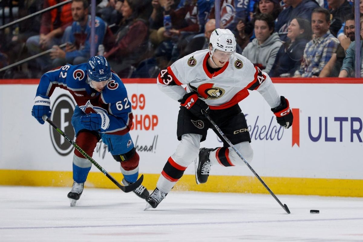 Jan 8, 2026; Denver, Colorado, USA; Ottawa Senators defenseman Tyler Kleven (43) controls the puck ahead of Colorado Avalanche left wing Artturi Lehkonen (62) in the third period at Ball Arena. Mandatory Credit: Isaiah J. Downing-Imagn Images