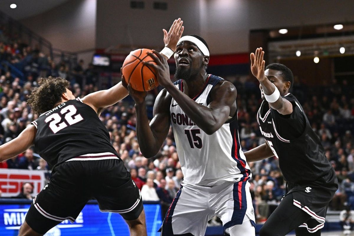 Jan 8, 2026; Spokane, Washington, USA; Gonzaga Bulldogs forward Graham Ike (15) shoots the ball against Santa Clara Broncos forward Allen Graves (22) and Santa Clara Broncos guard Thierry Darlan (15) in the first half at McCarthey Athletic Center. Mandatory Credit: James Snook-Imagn Images