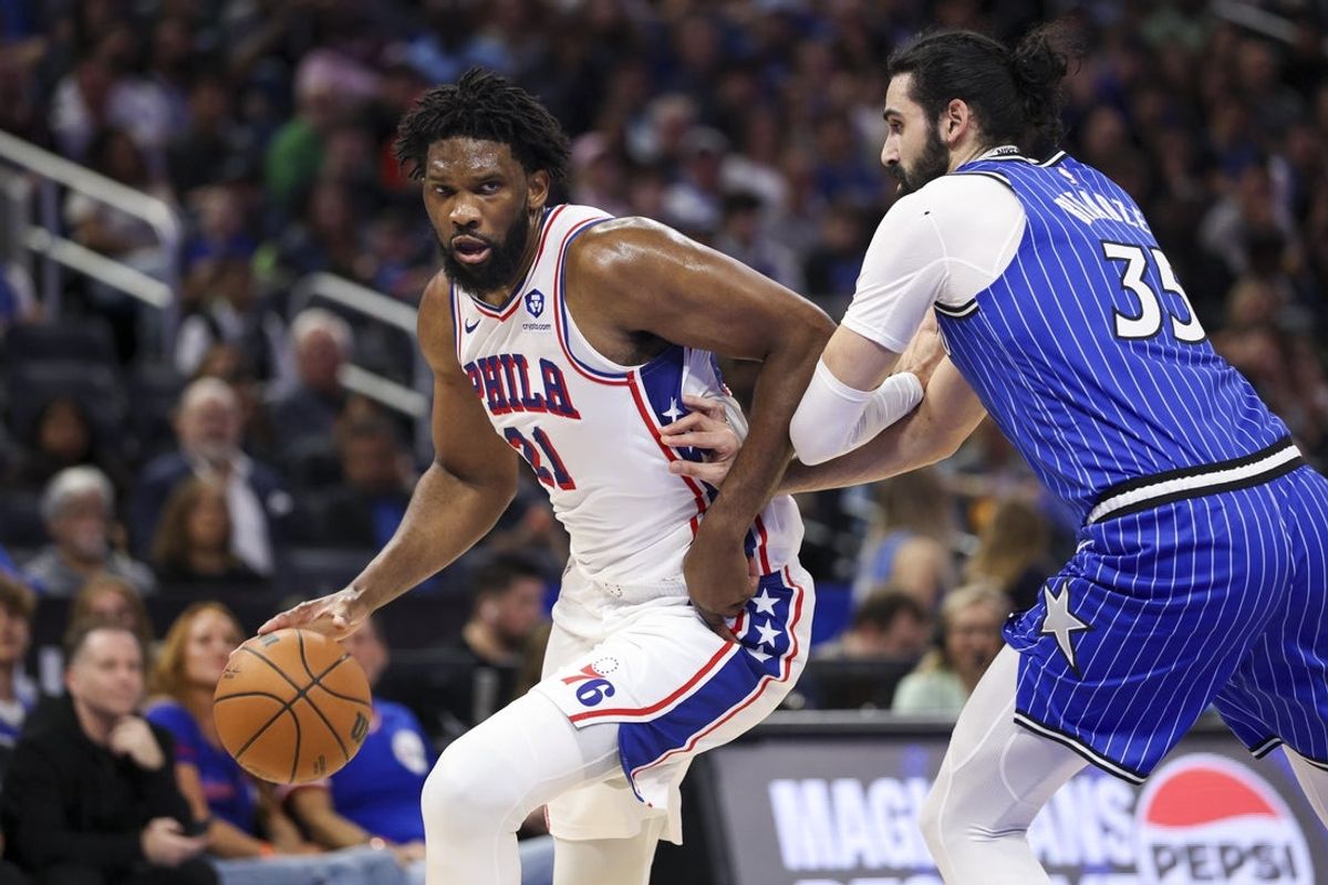 Jan 9, 2026; Orlando, Florida, USA; Philadelphia 76ers center Joel Embiid (21) drives to the basket past Orlando Magic center Goga Bitadze (35) in the second quarter at Kia Center. Mandatory Credit: Nathan Ray Seebeck-Imagn Images