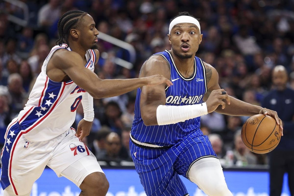 Jan 9, 2026; Orlando, Florida, USA; Orlando Magic center Wendell Carter Jr. (34) drives to the basket past Philadelphia 76ers guard Tyrese Maxey (0) in the fourth quarter at Kia Center. Mandatory Credit: Nathan Ray Seebeck-Imagn Images