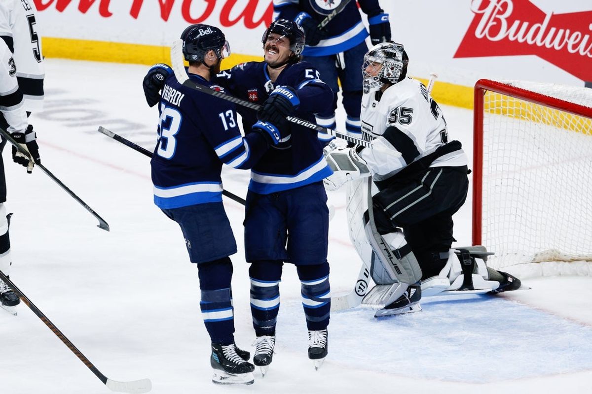 Jan 9, 2026; Winnipeg, Manitoba, CAN; Winnipeg Jets forward Mark Scheifele (55) is congratulated by Winnipeg Jets forward Gabriel Vilardi (13) for scoring against the Los Angeles Kings during the second period at Canada Life Centre. Mandatory Credit: Terrence Lee-Imagn Images