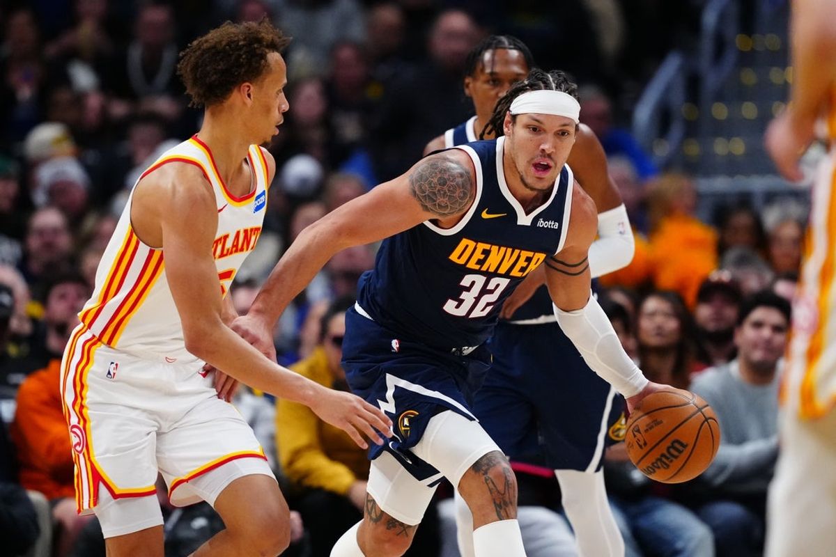 Jan 9, 2026; Denver, Colorado, USA; Atlanta Hawks guard Dyson Daniels (5) defends on Denver Nuggets forward Aaron Gordon (32) in the second quarter at Ball Arena. Mandatory Credit: Ron Chenoy-Imagn Images