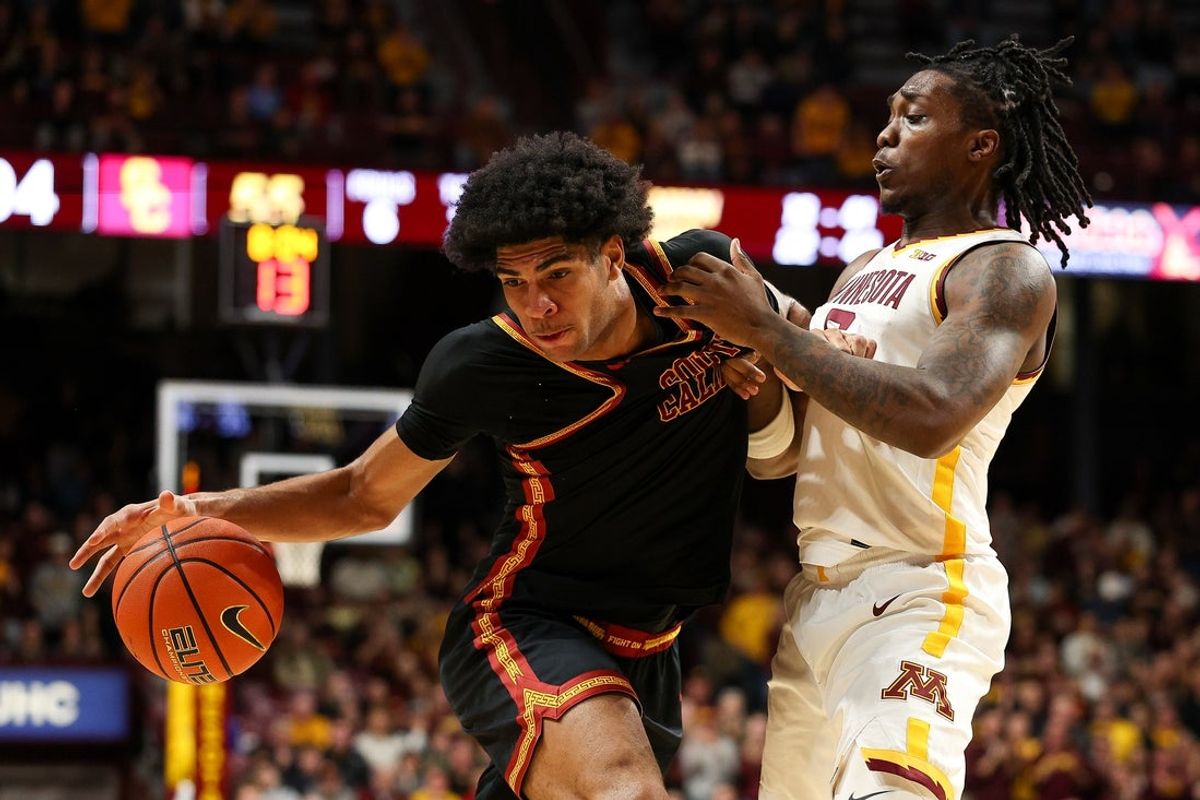 Jan 9, 2026; Minneapolis, Minnesota, USA; Southern California Trojans forward Jacob Cofie (6) drives into Minnesota Golden Gophers guard Langston Reynolds (6) during the second half at Williams Arena. Mandatory Credit: Matt Krohn-Imagn Images