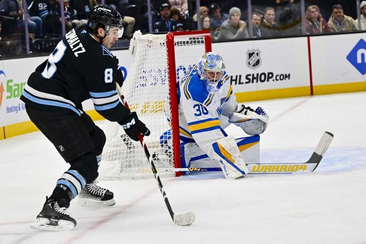 Jan 9, 2026; Salt Lake City, Utah, USA; St. Louis Blues goalie Joel Hofer (30) looks to block a shot by Utah Mammoth center Nick Schmaltz (8) during second period at Delta Center. Mandatory Credit: Peter Creveling-Imagn Images