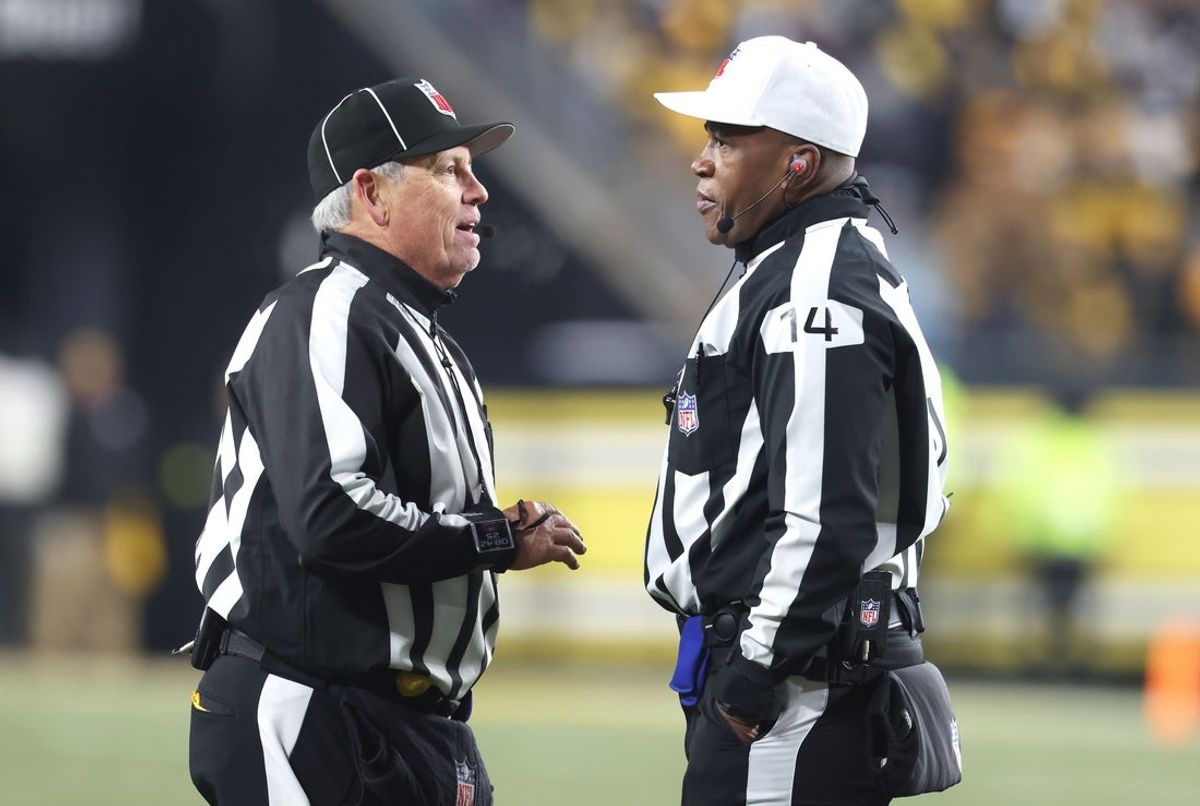 Jan 4, 2026; Pittsburgh, Pennsylvania, USA;  NFL line judge Jeff Seeman (left) and referee Shawn Smith (14) discuss a call during the fourth quarter between the Baltimore Ravens and the Pittsburgh Steelers at Acrisure Stadium. Mandatory Credit: Charles LeClaire-Imagn Images