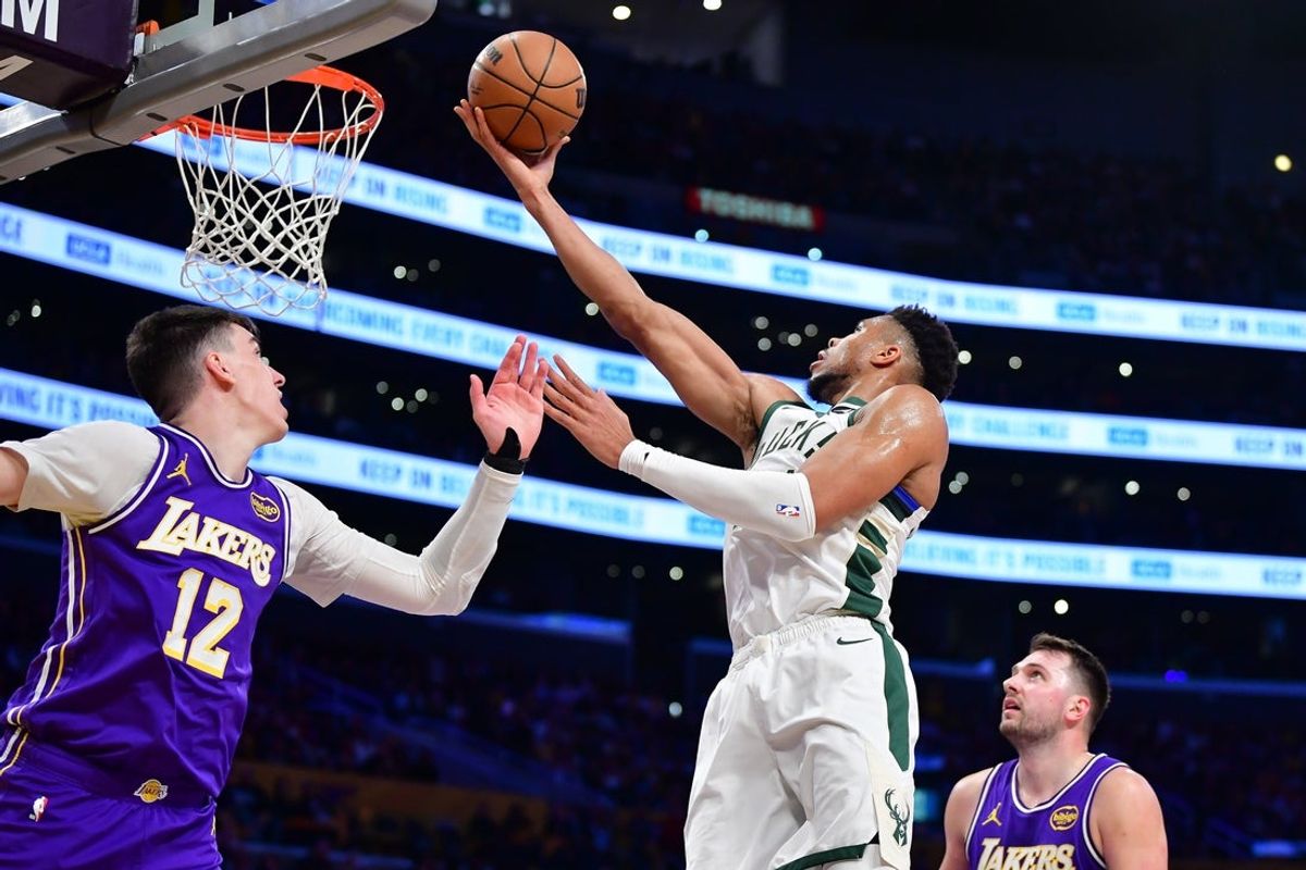Jan 9, 2026; Los Angeles, California, USA; Milwaukee Bucks forward Giannis Antetokounmpo (34) moves to the basket against Los Angeles Lakers forward Jake LaRavia (12) during the first half at Crypto.com Arena. Mandatory Credit: Gary A. Vasquez-Imagn Images