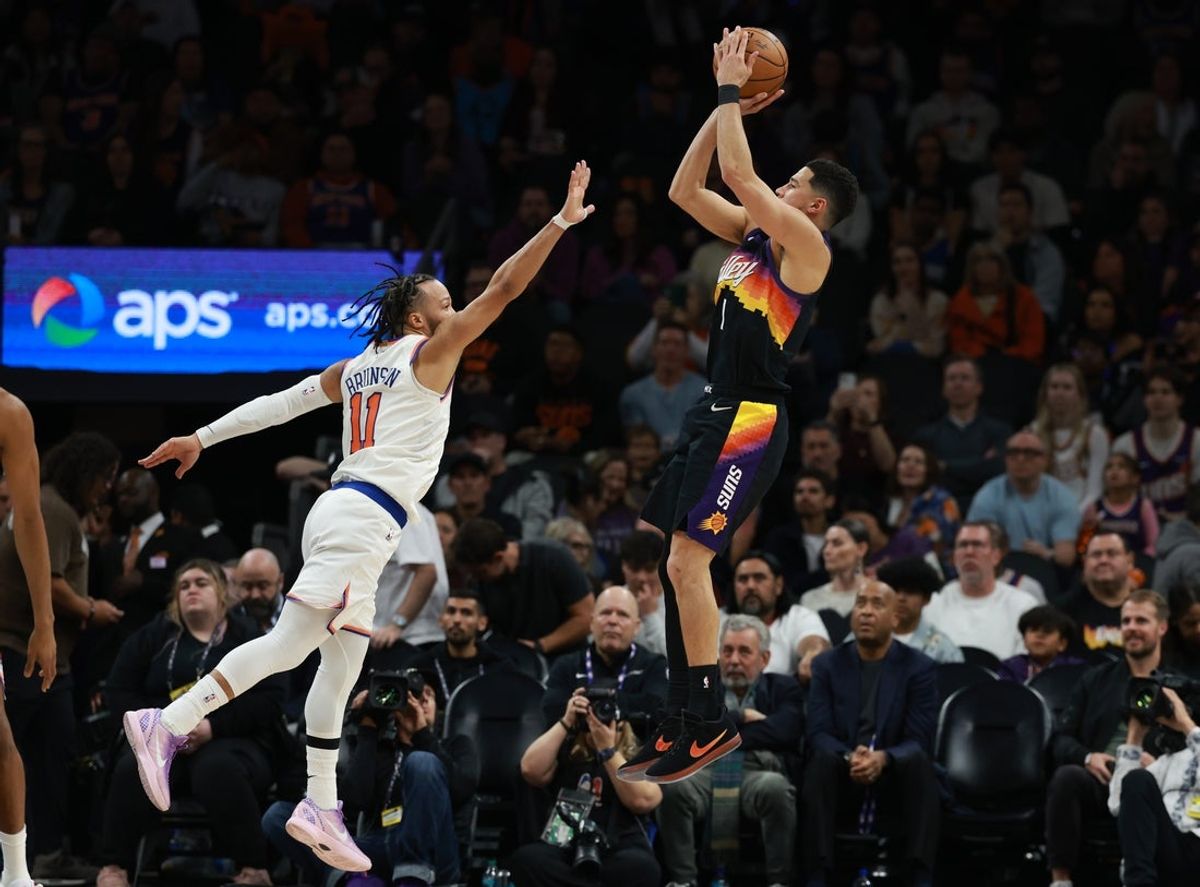 Jan 9, 2026; Phoenix, Arizona, USA; Phoenix Suns guard Devin Booker (1) shoots the ball against New York Knicks guard Jalen Brunson (11) in the second half at Mortgage Matchup Center. Mandatory Credit: Mark J. Rebilas-Imagn Images