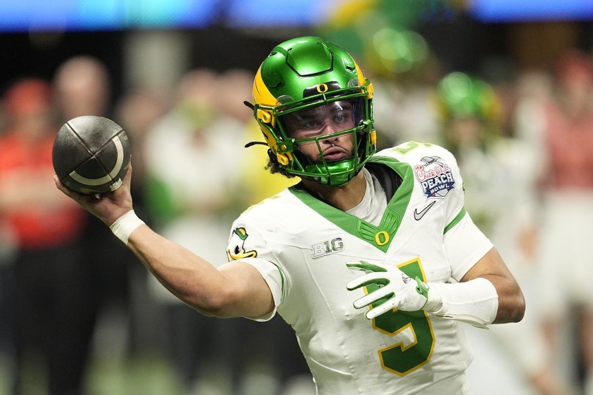Jan 9, 2026; Atlanta, GA, USA; Oregon Ducks quarterback Dante Moore (5) throws a pass during the fourth quarter the 2025 Peach Bowl and semifinal game of the College Football Playoff at Mercedes-Benz Stadium. Mandatory Credit: Dale Zanine-Imagn Images