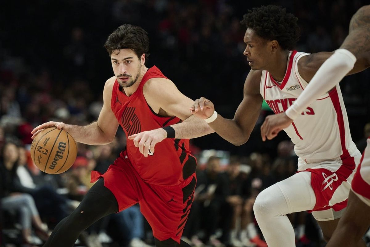 Jan 9, 2026; Portland, Oregon, USA; Portland Trail Blazers forward Deni Avdija (8) drives to the basket during the second half against Houston Rockets guard Amen Thompson (1) at Moda Center. Mandatory Credit: Troy Wayrynen-Imagn Images