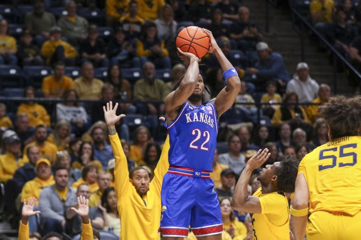 Jan 10, 2026; Morgantown, West Virginia, USA; Kansas Jayhawks guard Darryn Peterson (22) shoots over West Virginia Mountaineers guard Honor Huff (3) during the first half at Hope Coliseum. Mandatory Credit: Ben Queen-Imagn Images