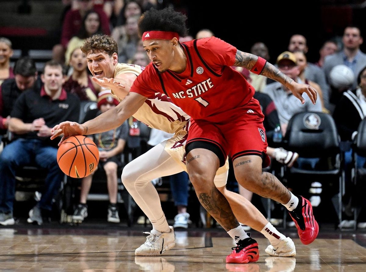Jan 10, 2026; Tallahassee, Florida, USA; Florida State Seminoles forward Alex Steen (25) dives for the ball against  North Carolina State Wolfpack forward Darrion Williams (1) during the first half at Donald L. Tucker Center. Mandatory Credit: Melina Myers-Imagn Images