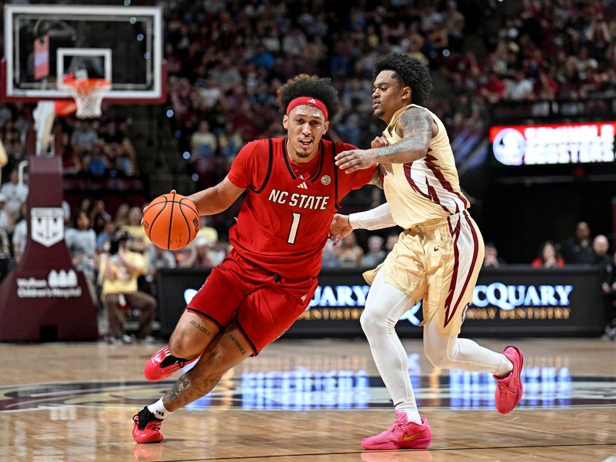 Jan 10, 2026; Tallahassee, Florida, USA; North Carolina State Wolfpack forward Darrion Williams (1) drives to the net past Florida State Seminoles guard Martin Somerville (1) during the first half at Donald L. Tucker Center. Mandatory Credit: Melina Myers-Imagn Images