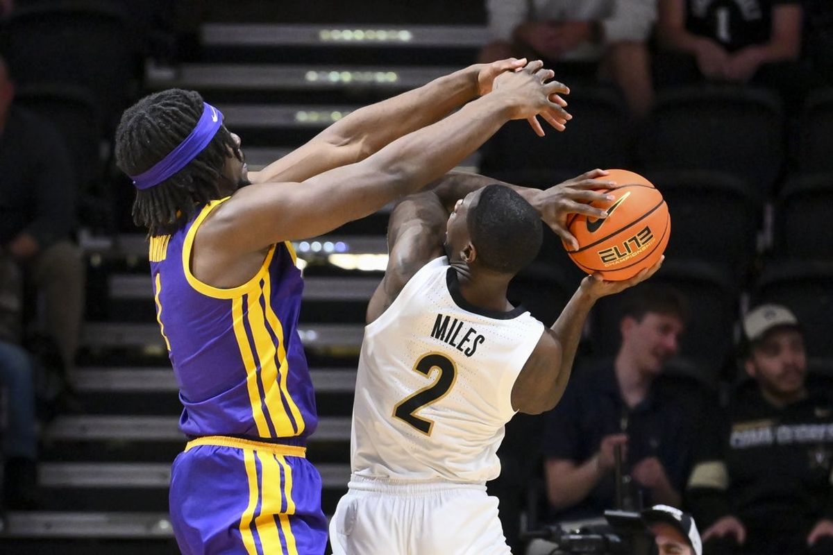 Jan 10, 2026; Nashville, Tennessee, USA; Louisiana State Tigers center Michael Nwoko (1) blocks the shot of Vanderbilt Commodores guard Duke Miles (2) during the first half at Memorial Gymnasium. Mandatory Credit: Steve Roberts-Imagn Images