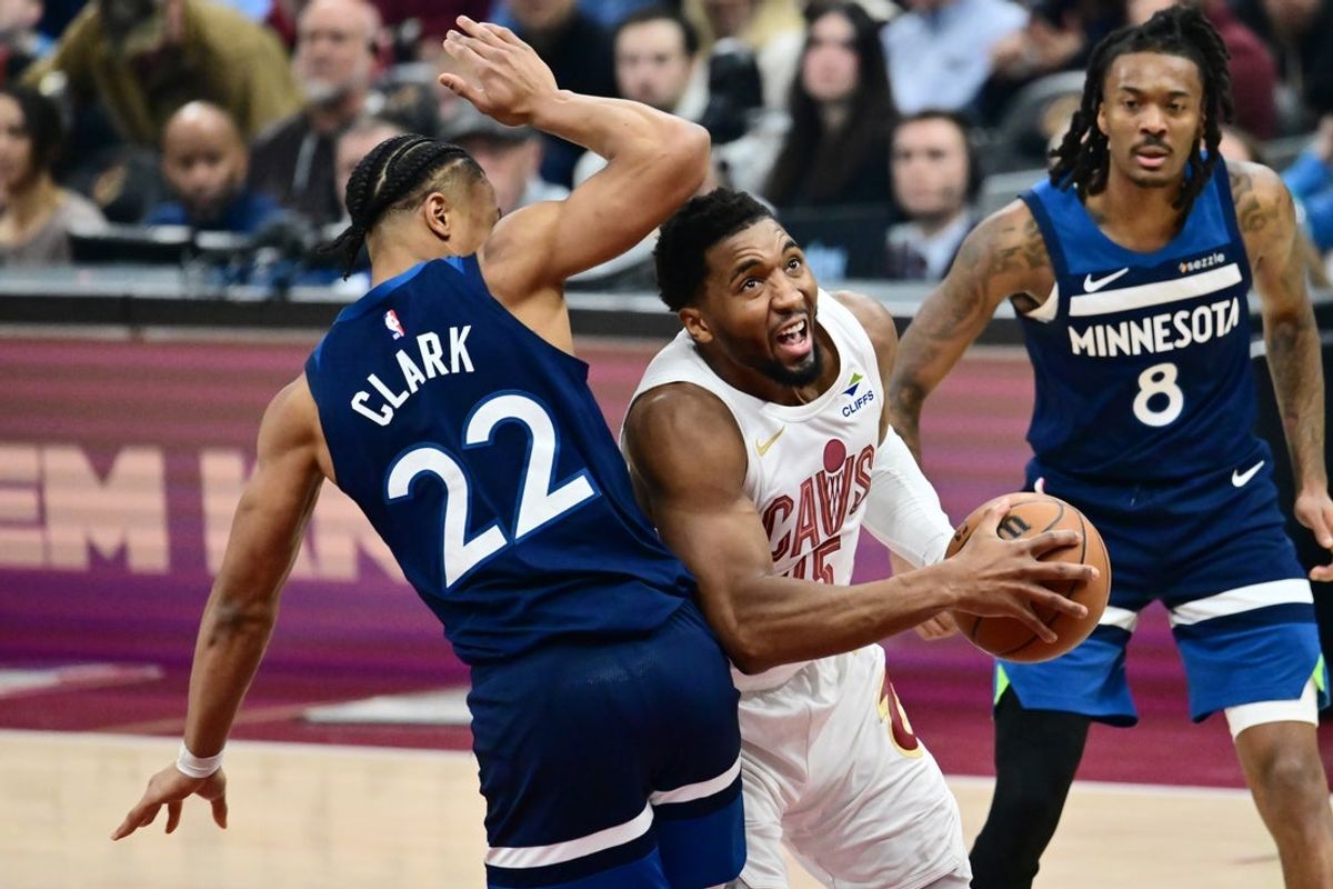 Jan 10, 2026; Cleveland, Ohio, USA; Cleveland Cavaliers guard Donovan Mitchell (45) drives to the basket against Minnesota Timberwolves guard Jaylen Clark (22) during the first half at Rocket Arena. Mandatory Credit: Ken Blaze-Imagn Images