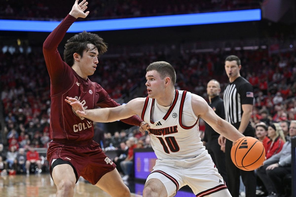 Jan 10, 2026; Louisville, Kentucky, USA;  Louisville Cardinals guard Isaac McKneely (10) dribbles against Boston College Eagles guard Luka Toews (10) during the second half at KFC Yum! Center.  Mandatory Credit: Jamie Rhodes-Imagn Images